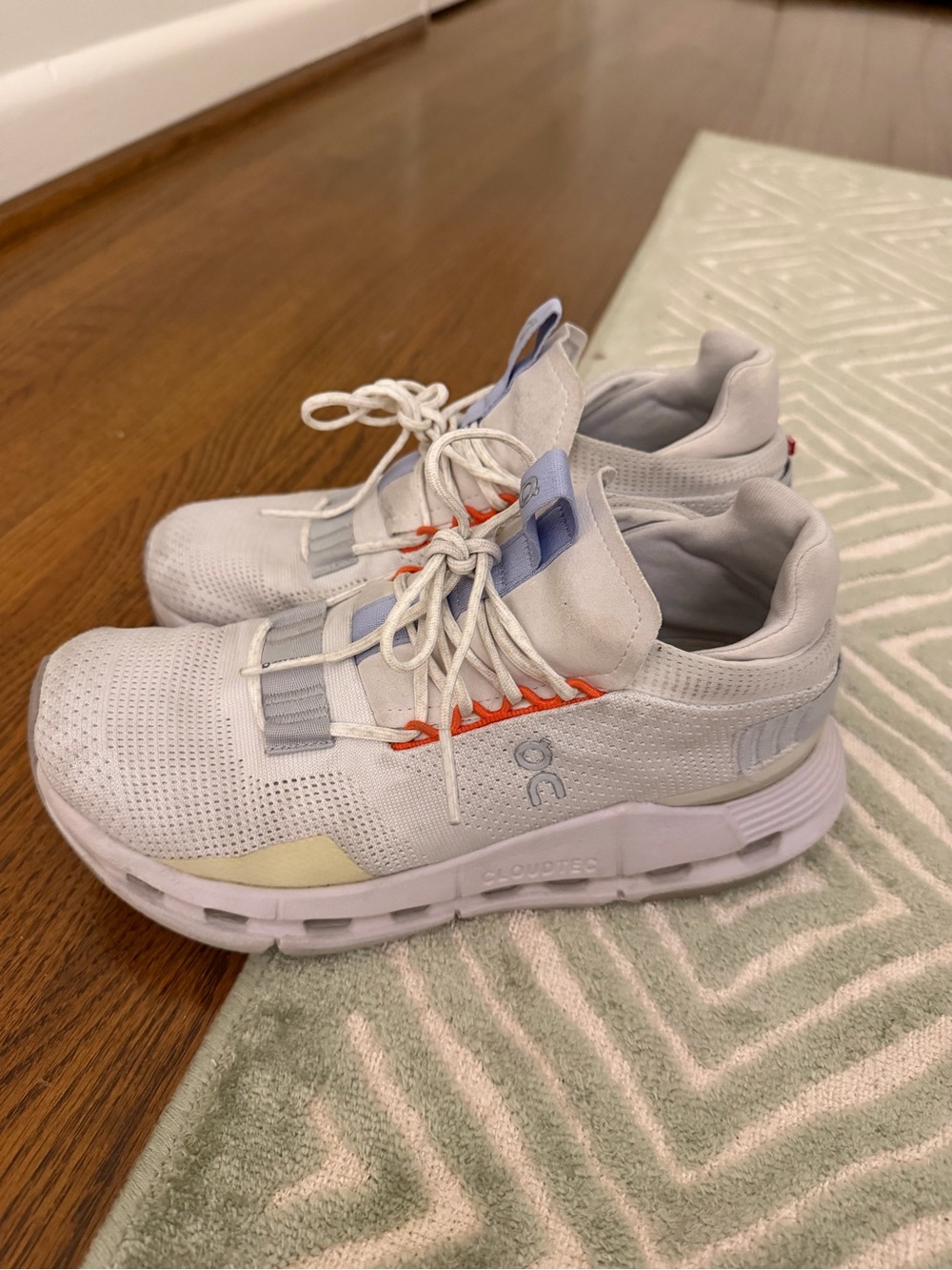 On Running Women’s Cloud White Athletic Sneakers with Orange Accents